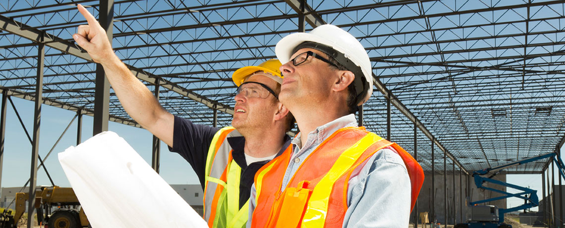 Two Men in Hardhats at Build Site